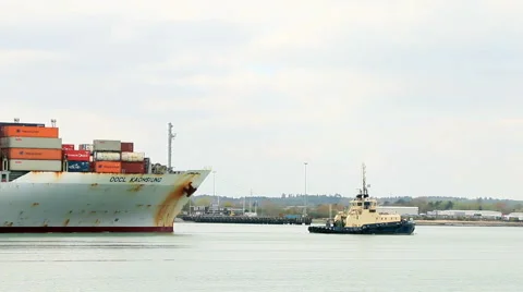 Tug boat pulling a container ship speed up Stock Footage 46074676