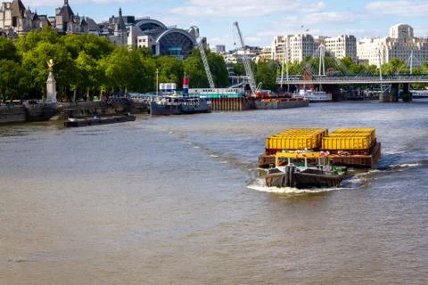 Tug boat pulling freight through London Stock Photos