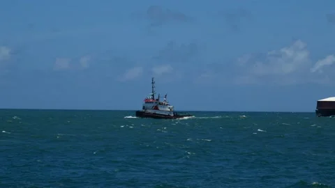 Tug Boat pulling RORO barge at sea 2 Stock Footage 192347819