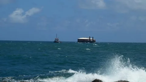 Tug Boat pulling RORO barge at sea 1 Stock Footage 192367565