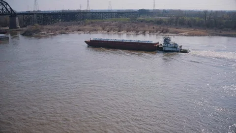 Tug boat pushing a barge Stock Footage 127842909