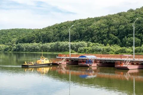 Tug boat sets section of the pontoon bridge Stock Photos