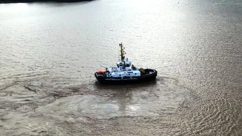 Tug boat turning in the river. Stock Footage 119449371