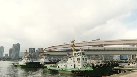 Tug boats moored at bay with elevated highway and Minato district. Tokyo, Japan. Stock Footage 247135804