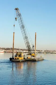 Tug Michael pushing barge with construction crane Stock Photos