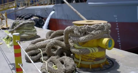 A tug moored to the pier is draining water. Stock Footage 166390091
