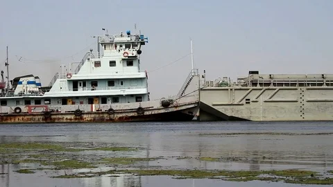 The tug moves an empty barge Video stock 78747713