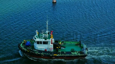 Tug moving in the port area for cargo vessel assistance Stock Footage 159673707