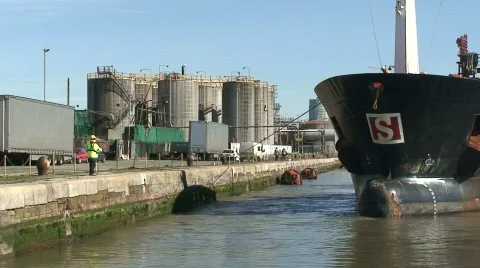 Tug pulling huge tanker into dock. HD 1080i Stock Footage 67001