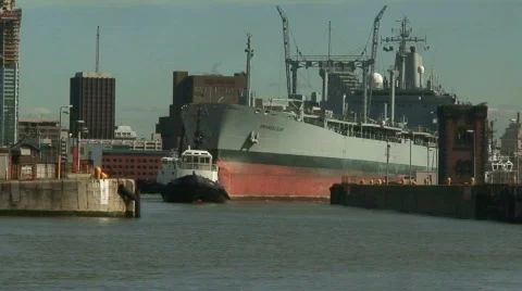 Tug pulling huge tanker into dock. HD 1080i Stock Footage 67129