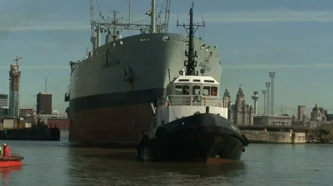 Tug pulling huge tanker into dock. HD 1080i Stock Footage 67203