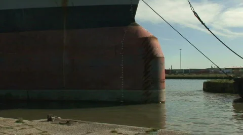 Tug pulling huge tanker into dock. HD 1080i Stock Footage 67253