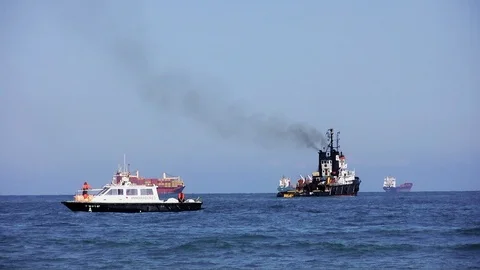 Tug pulling in a shipwreck in the beach of Valencia city. Video stock 108783041
