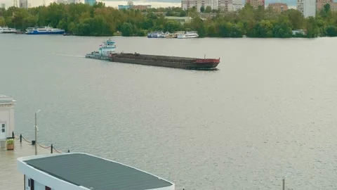 The tug pushes the barge on Moskva river in Moscow. Water transport in Russia Stock Footage 145426366