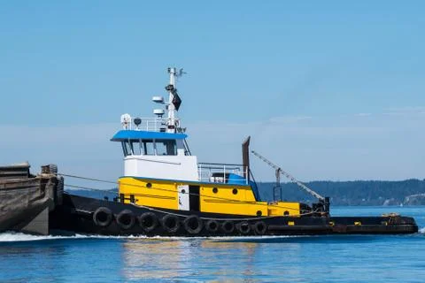 Tug pushing a barge Stock Photos