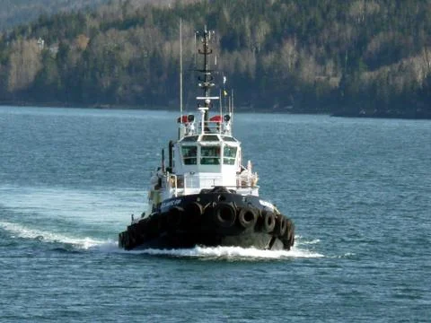 Tug sailing on the river Stock Photos