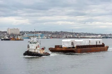 Tug Sirius pulling barge loaded with modular homes Stock Photos