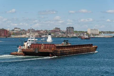 Tug Sirius pushing empty barge Stock Photos