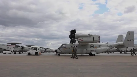 Tug towing U.S. Navy CMV-22B Osprey on arrival at Naval Station Norfolk Stock Footage 271233735