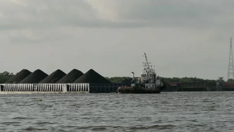 Tugboat and barge with bulk load of coal on the river Stock Footage 132610640