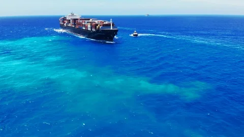 Tugboat and Container Cargo Ship at Sea Near Freeport Harbor, Bahamas Stock Footage 107639195