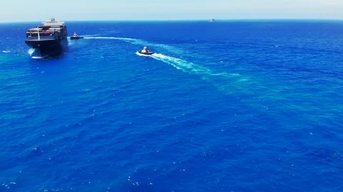Tugboat and Container Cargo Ship at Sea Near Freeport Harbor, Bahamas Stock Footage 107639341