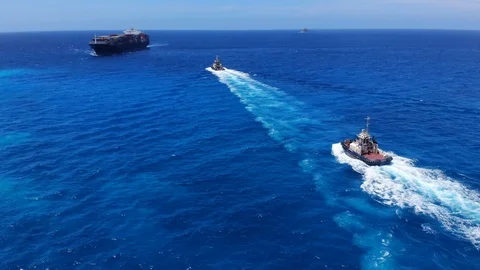 Tugboat and Container Cargo Ship at Sea Near Freeport Harbor, Bahamas Stock Footage 107639656