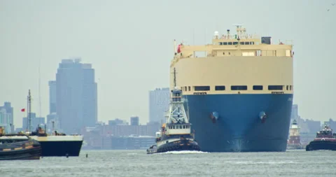 Tugboat escorts The vessel GRAND RUBY, Vehicles Carrier out of Harbor Stock Footage 152861859
