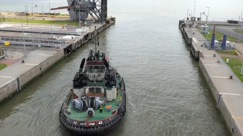 A tugboat exits the lock into the port. Stock Footage 131464832