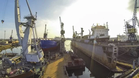 The tugboat  moves the floating crane to another place. Sunset. Video stock 87015669