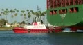 Tugboat Provides Steerage For Container Ship HD Footage