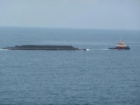 Tugboat  pulling cargo Stock Photos