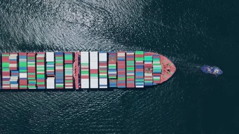 Tugboat pulling a large loaded container ship at sea Stock Footage 337576700