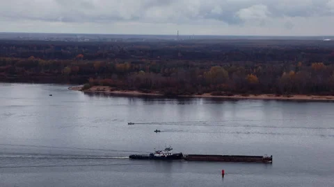 A Tugboat Pushes A Long Barge Along The River In Nizhny Novgorod Against A Backd Stock Footage 341872254