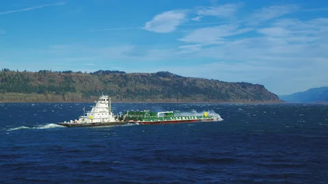 Tugboat pushing hard against current and wind on the Columbia River Stock Footage 228482762