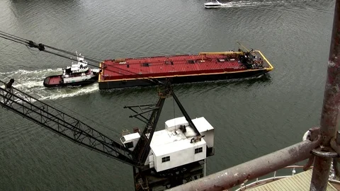 Tugboat pushing large barge through busy harbor Video stock 123724845