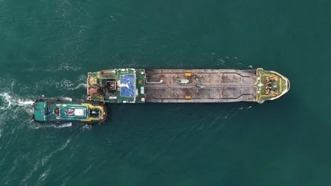 Tugboat pushing large cargo barge aerial top down view Stock-Footage 328895898