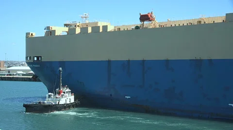 Tugboat pushing ship Stock Footage 34104761
