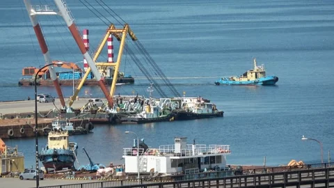 Tugboat towing a barge into a harbor dock, Hakodate, Japan, 2026.09.10. Stock Footage 345363672
