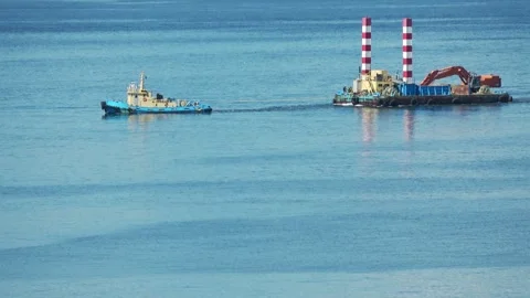 Tugboat towing a construction barge on blue sea, Hakodate, Japan, 2026.09.10. Stock Footage 345363170