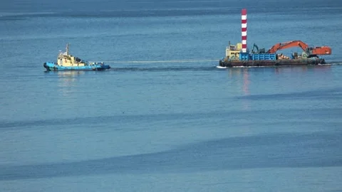 Tugboat towing a construction barge on blue sea, Hakodate, Japan, 2026.09.10. Stock Footage 345363185