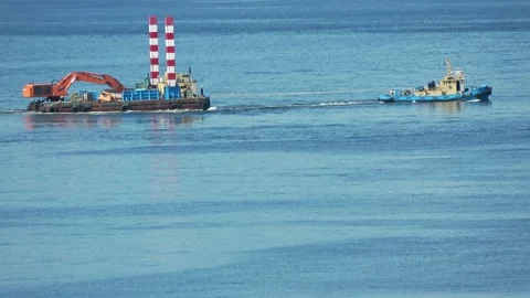 Tugboat towing a construction barge on blue sea, Hakodate, Japan, 2026.09.10. Stock Footage 345363301
