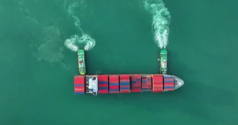 Tugboats Assisting Large Container Ship Maneuvering In Calm Harbor Waters E.. Stock Footage 335681240