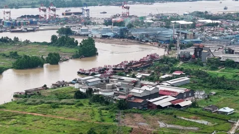 Tugboats lined up are parked on the edge of the Martapura River Stock Footage 334275452