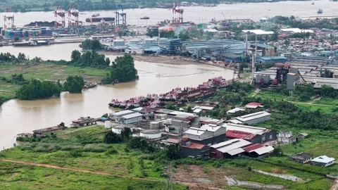 Tugboats lined up are parked on the edge of the Martapura River Stock Footage 334275477