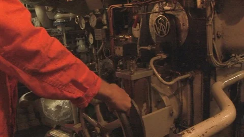 Tug’s engine room with engineer adjusting valve. Maassluis, The Netherlands Stock Footage 104224172