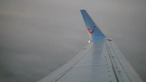 TUI airplane wing in the cloudy sky Stock Footage 115113956
