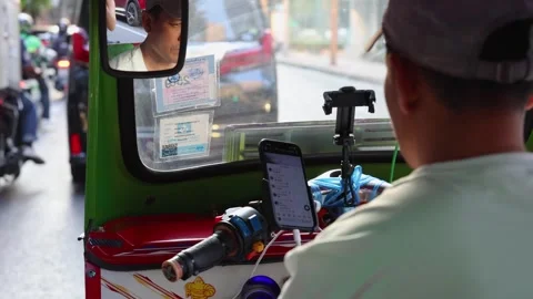 Tuk tuk driver using smartphone in Bangkok traffic jam Stock Footage 323891743