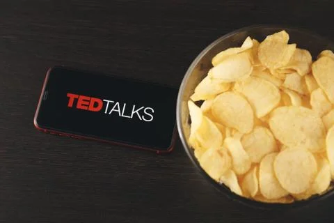 Tula Russia 07.05.2020 Ted Talks on the phone screen and snacks on the table. Stock Photos