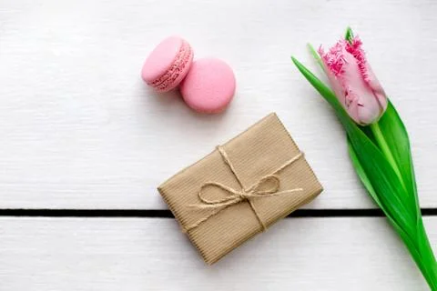 Tulip, gift boxes and macaroons wooden white background Stockfoto's